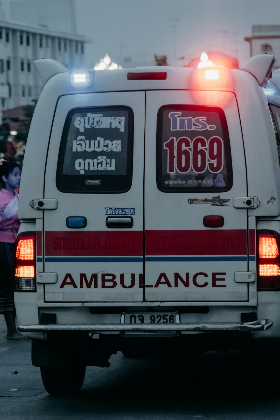 An ambulance with flashing lights is shown.