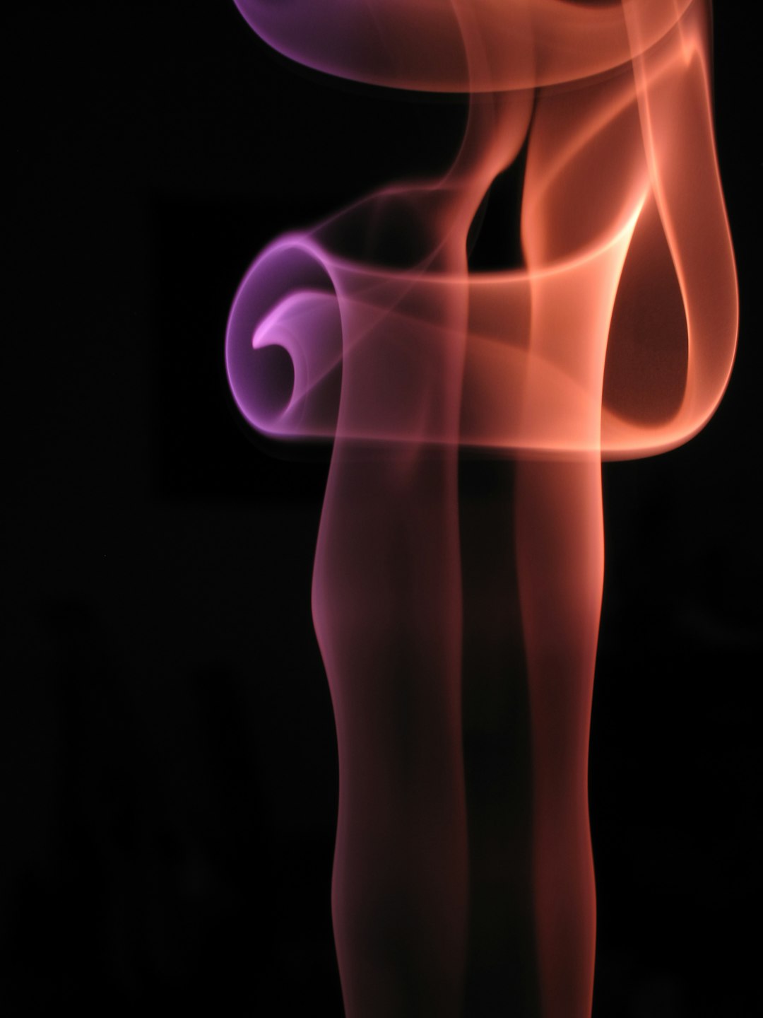 a blurry photo of a red and purple smoke