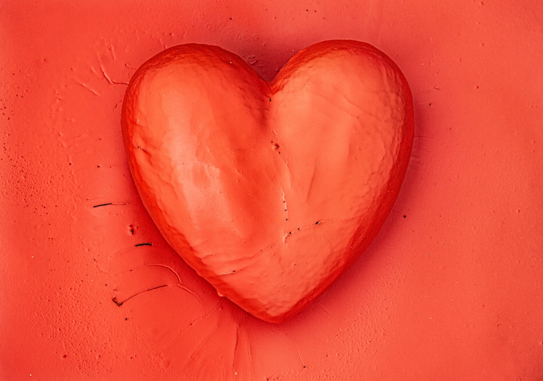 a heart shaped object on a red background