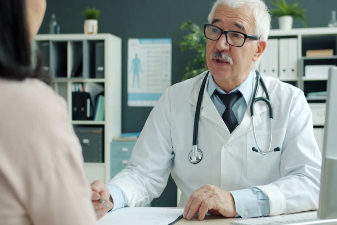 white and black cat lying beside baby