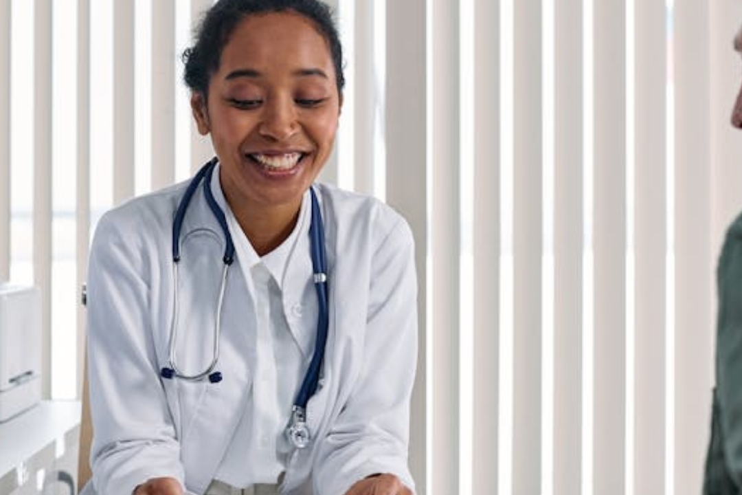 white and black cat lying beside baby