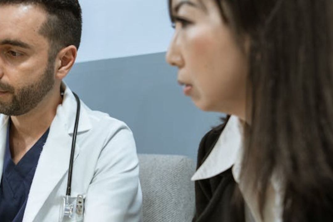 white and black cat lying beside baby
