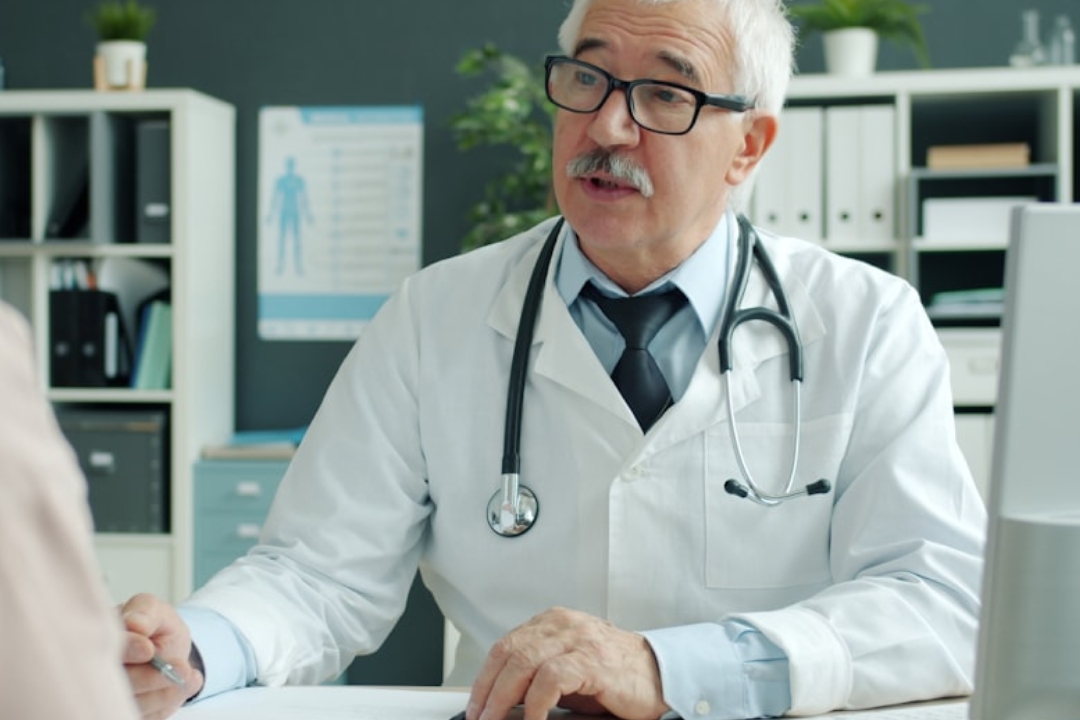 white and black cat lying beside baby