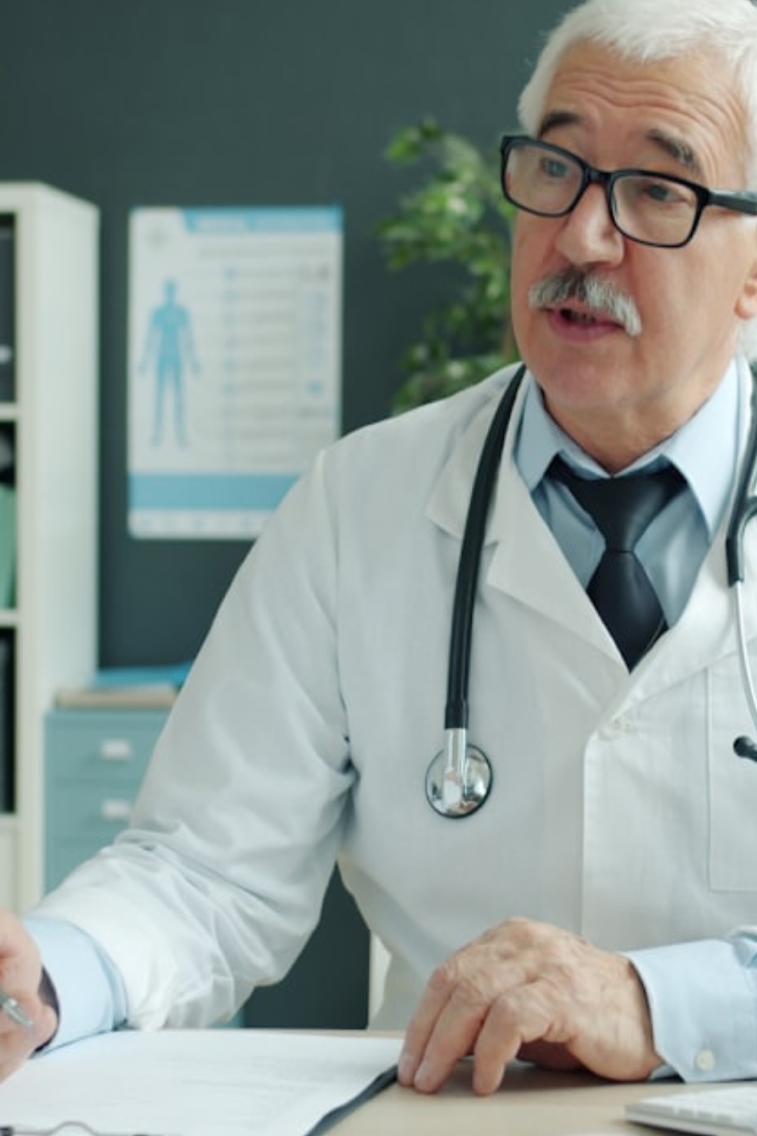 grayscale photo of person pouring water on persons hand