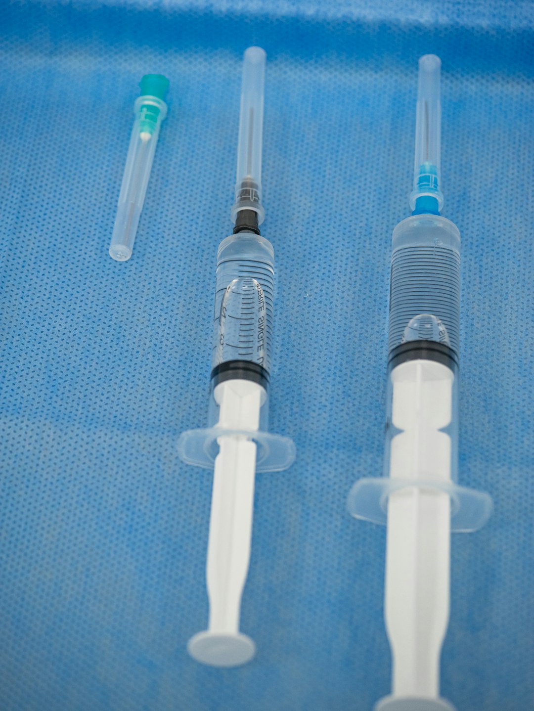 Syringes prepared for injection on a sterile surface.