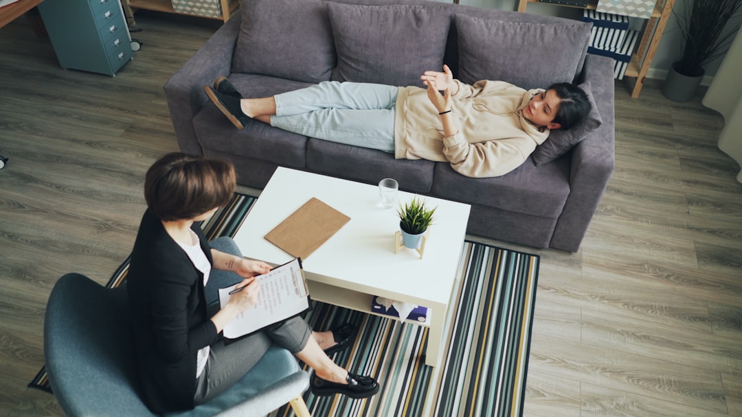 a man and woman sitting on a couch in a living room