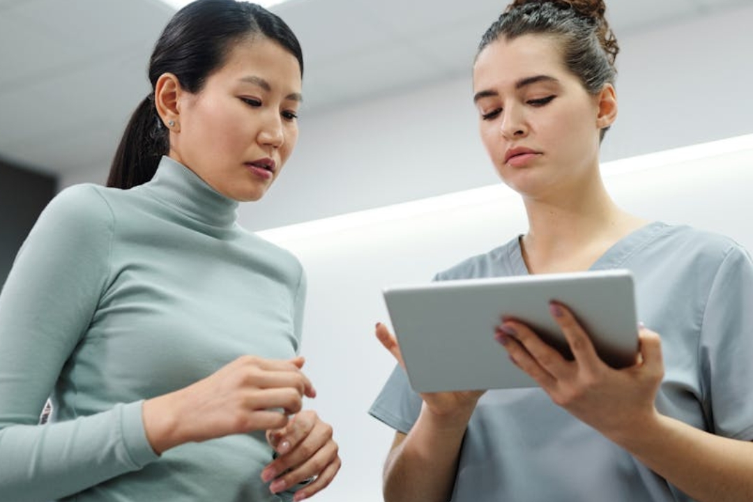 a woman sleeping in a bed with a white comforter